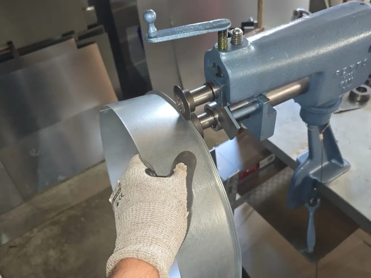 Close-up of bead roller forming sheet metal