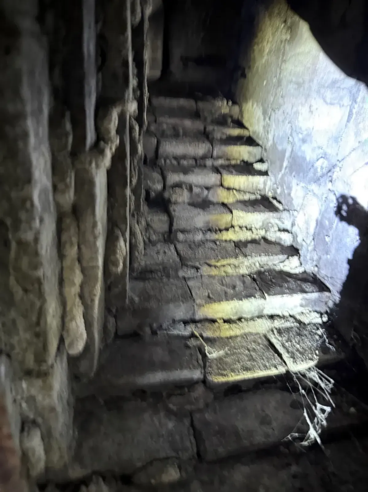 Deteriorated smoke chamber with crumbling mortar and exposed brick before repair