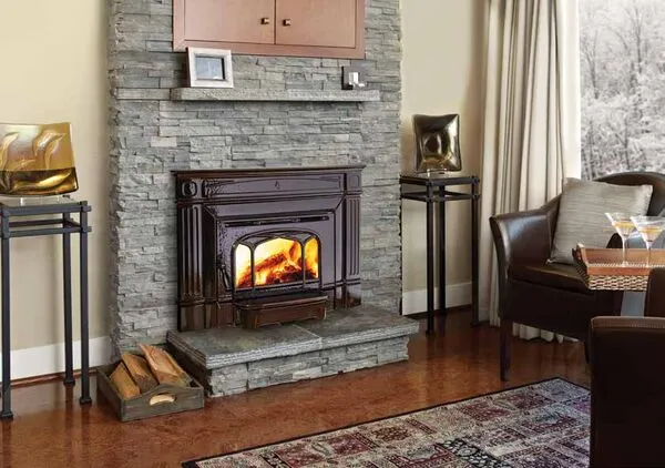 Hampton Hi1150 small cast iron wood insert in stone fireplace