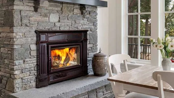 Hampton Hi500 large cast iron hybrid wood insert in stone fireplace